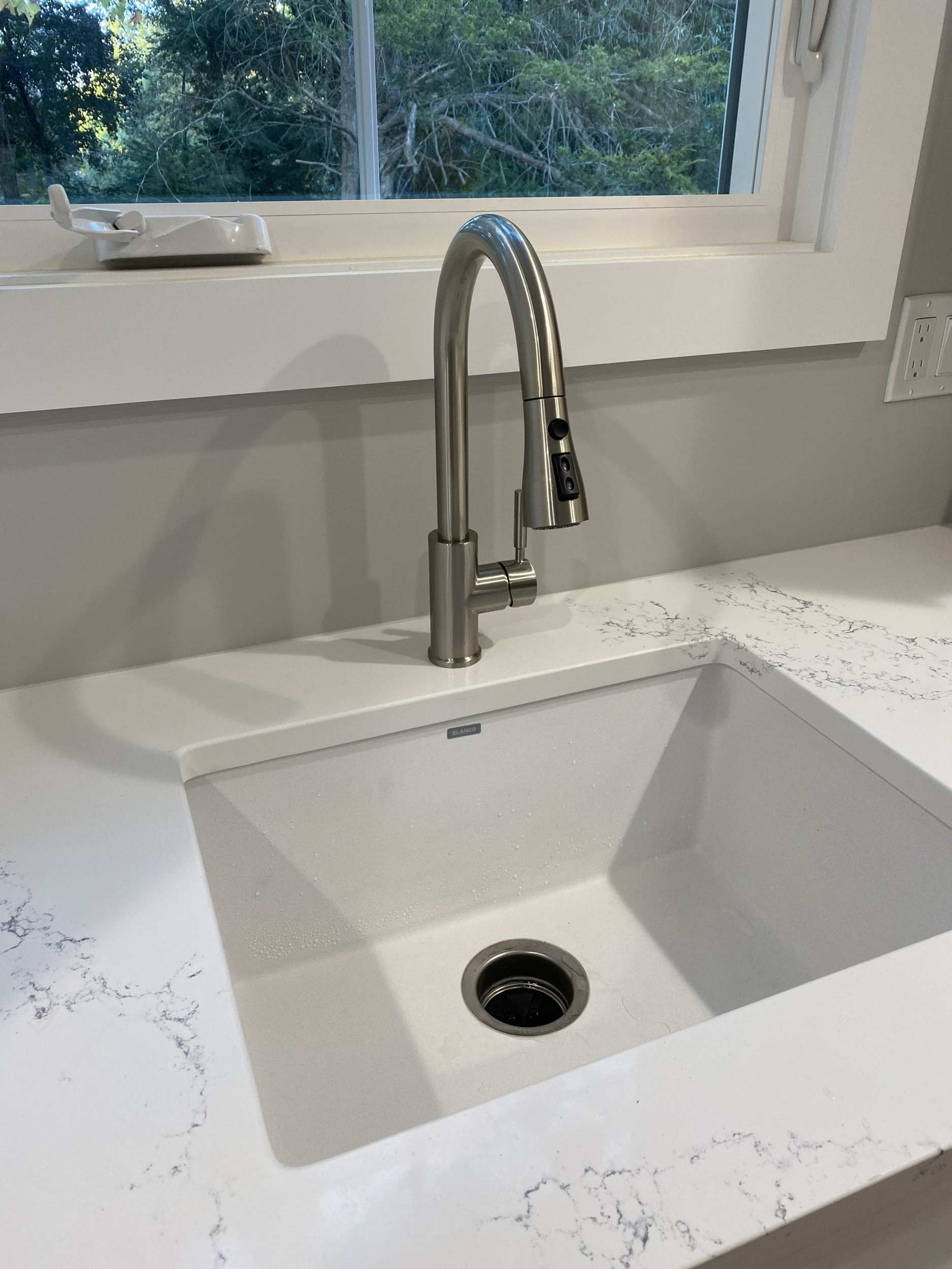 the kitchen faucet in brushed nickel
