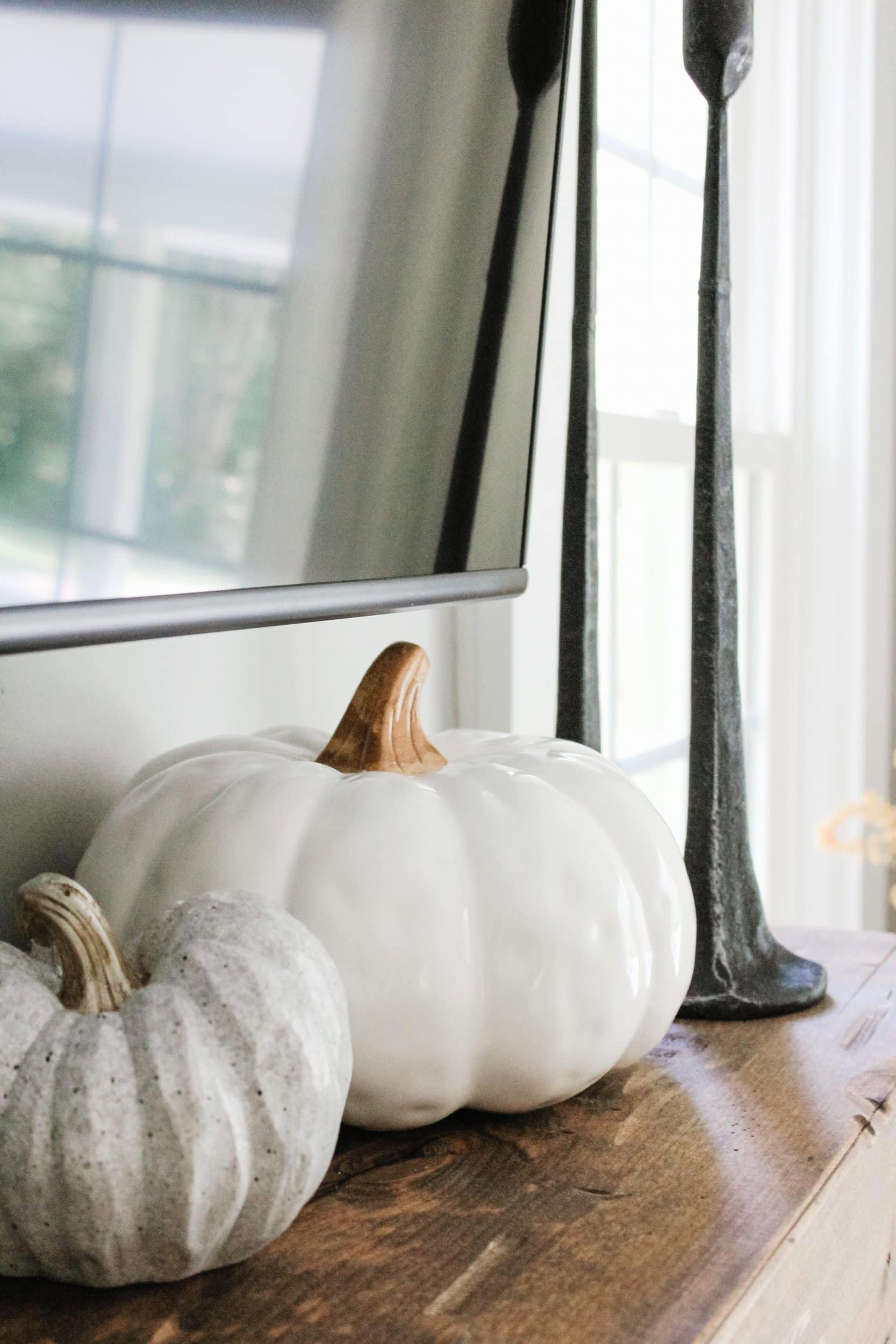 Faux white ceramic pumpkin, faux grey spotted pumpkin, black cast iron candle sticks