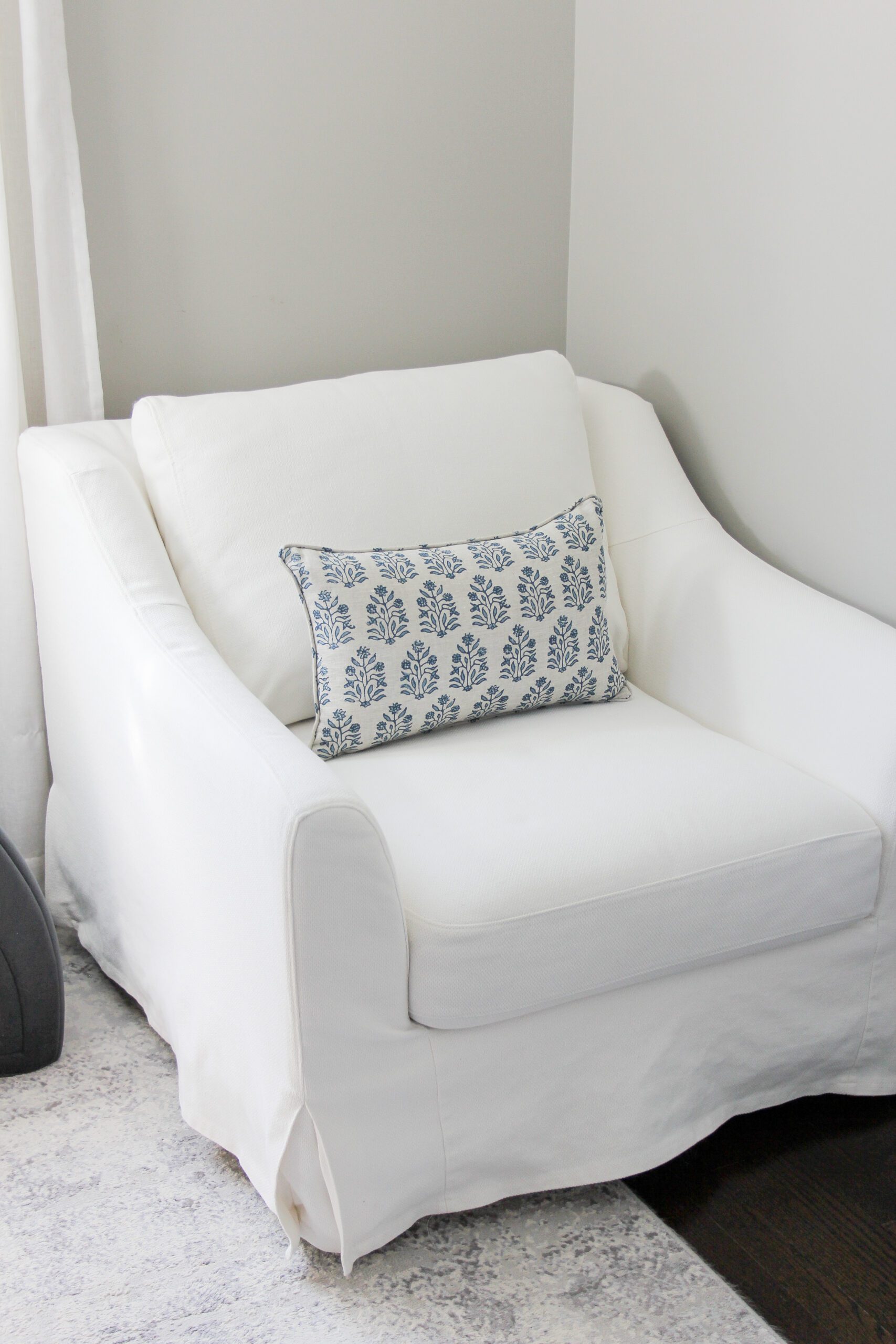 ikea farlov slipcovered chair with a patterned spring lumbar pillow
